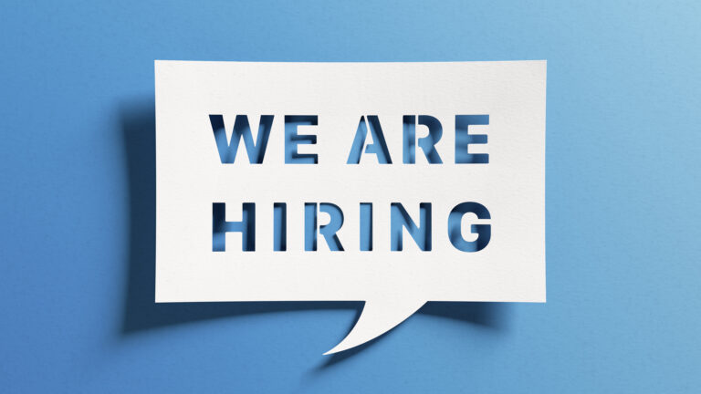 cut-out stencil with the words "we are hiring".